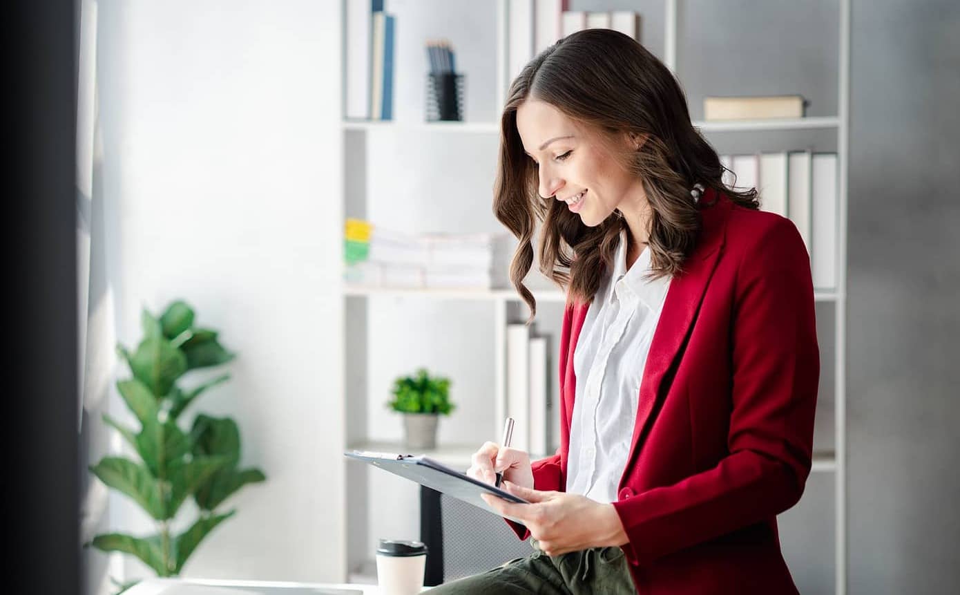 entrepreneur woman smiling writing